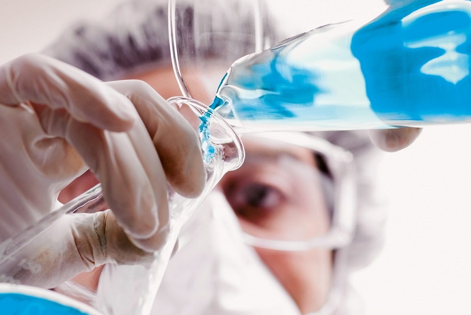Laboratory assistant works with a flask