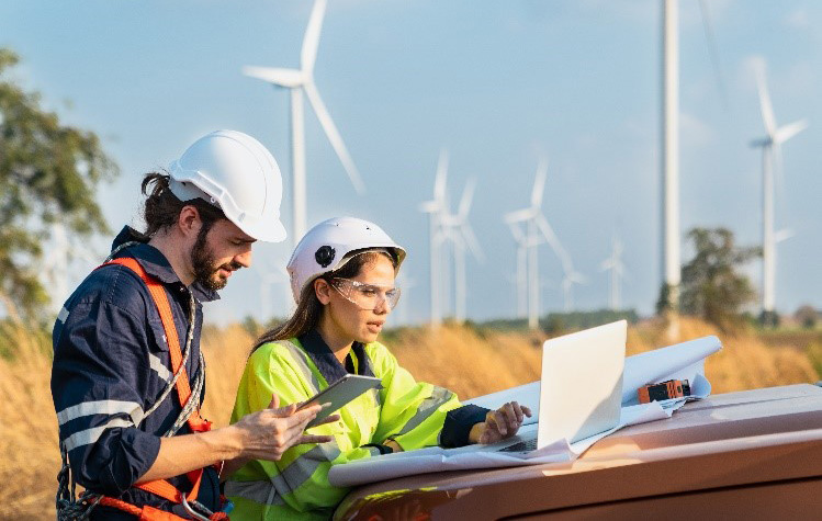 Two environmental engineers work outdoors Two environmental engineers work outdoors