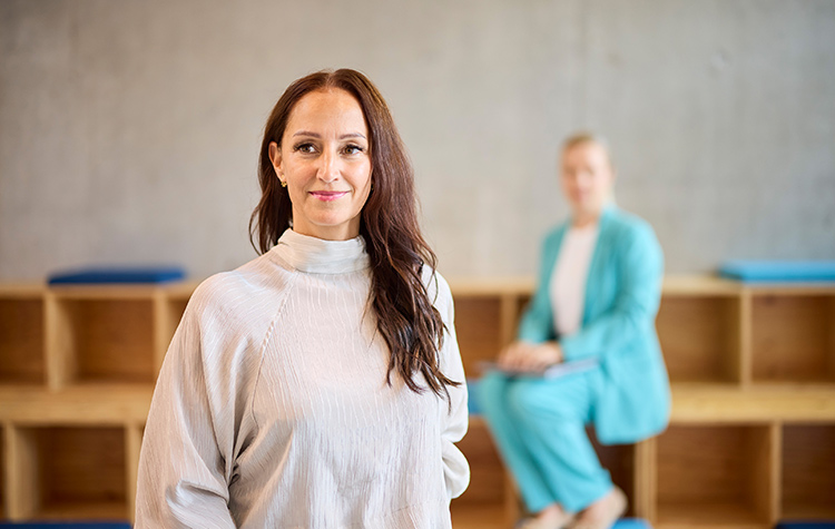 Young female employee standing in an open-plan office