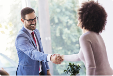 Two people shake hands cheerfully